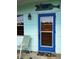 Up close exterior shot of home featuring light blue paint, blue door, and lush front lawn at 114 Hickory St, New Smyrna Beach, FL 32168