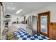 This kitchen features blue and white tile flooring with stainless steel appliances, and a wood-framed door at 114 Hickory St, New Smyrna Beach, FL 32168