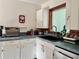 Bright kitchen with white cabinetry and a window providing natural light at 114 Hickory St, New Smyrna Beach, FL 32168