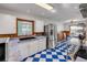 Kitchen with modern stainless steel refrigerator and an adjacent dining area at 114 Hickory St, New Smyrna Beach, FL 32168