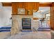 Cozy living room featuring wood paneling, fireplace and hearth, and decor at 114 Hickory St, New Smyrna Beach, FL 32168