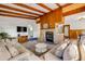 Comfortable living room features a brick fireplace, wood-paneled walls, and unique flooring at 114 Hickory St, New Smyrna Beach, FL 32168