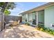 Inviting patio with outdoor seating and lush greenery surrounding the space at 114 Hickory St, New Smyrna Beach, FL 32168