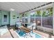 Relaxing screened-in patio area with seating, perfect for enjoying the outdoors at 114 Hickory St, New Smyrna Beach, FL 32168