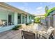 Charming patio with outdoor table and chairs, ideal for al fresco dining at 114 Hickory St, New Smyrna Beach, FL 32168
