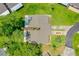 Overhead view of the home with lush trees, well-maintained landscaping, and private driveway at 115 Bob White Ct, Daytona Beach, FL 32119