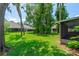 An outdoor screened-in back porch shows a hot tub with a view of the green lawn and trees at 115 Bob White Ct, Daytona Beach, FL 32119