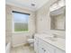 Updated bathroom with a window over the tub, toilet, and sink at 115 Bob White Ct, Daytona Beach, FL 32119