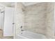 Bright bathroom showcasing a white tub and shower featuring stylish tile and modern fixtures at 115 Bob White Ct, Daytona Beach, FL 32119