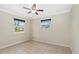 Bedroom featuring tile floors, two windows, and ceiling fan at 115 Bob White Ct, Daytona Beach, FL 32119