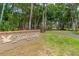 Elegant 'Hawks Landing' community sign, surrounded by lush greenery and mature trees at 115 Bob White Ct, Daytona Beach, FL 32119