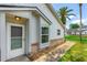 Close up of a home's front door that highlights the light fixtures and brick details at 115 Bob White Ct, Daytona Beach, FL 32119