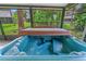 Enclosed hot tub offers a relaxing space, providing a private and comfortable outdoor experience at 115 Bob White Ct, Daytona Beach, FL 32119