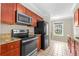 Updated kitchen features stainless steel appliances, granite countertops, and wood cabinetry at 115 Bob White Ct, Daytona Beach, FL 32119