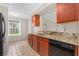 Cozy kitchen showcasing granite countertops, wood cabinets, stainless steel sink, and modern faucet at 115 Bob White Ct, Daytona Beach, FL 32119
