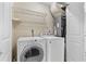 Functional laundry room equipped with a washer, dryer, and convenient wire shelving at 115 Bob White Ct, Daytona Beach, FL 32119