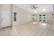 Bright and airy living room showcases tile flooring, skylights, ceiling fan, and access to the outdoors at 115 Bob White Ct, Daytona Beach, FL 32119