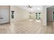 Expansive living room features tile flooring, skylights, ceiling fan, and natural light from large windows at 115 Bob White Ct, Daytona Beach, FL 32119