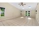 Open living room boasts tile flooring, skylights, ceiling fan, and inviting ambiance at 115 Bob White Ct, Daytona Beach, FL 32119