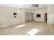 Spacious living area with tile flooring, ceiling fan, and open layout connected to the kitchen at 115 Bob White Ct, Daytona Beach, FL 32119