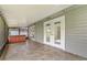 An outdoor tiled patio with doors, lights and a hot tub at 115 Bob White Ct, Daytona Beach, FL 32119