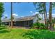 A covered screened-in back porch shows a hot tub and back doors at 115 Bob White Ct, Daytona Beach, FL 32119