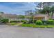 Community pool area with mailbox kiosk surrounded by lush landscaping and a walking path at 115 Bob White Ct, Daytona Beach, FL 32119