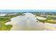 Wide angle aerial view of a river and its banks with boat trailing behind it at 128 Godfrey Rd, Edgewater, FL 32141