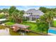 Scenic backyard featuring an in-ground pool, private dock, and lush landscaping at 128 Godfrey Rd, Edgewater, FL 32141