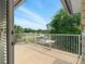 Open balcony with white railing, offering views of the surrounding neighborhood and trees at 128 Godfrey Rd, Edgewater, FL 32141