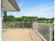 Spacious balcony with white railings offering views of lush greenery and neighborhood at 128 Godfrey Rd, Edgewater, FL 32141