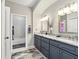 Bathroom with double vanity, framed mirrors, and a separate room for the toilet and shower at 128 Godfrey Rd, Edgewater, FL 32141