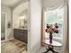 Bright bathroom showcasing double vanity, neutral color scheme, archway and flower arrangement at 128 Godfrey Rd, Edgewater, FL 32141
