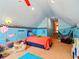 Whimsical bedroom with colorful Finding Nemo wall decor and decoratively painted blue walls and vaulted ceiling at 128 Godfrey Rd, Edgewater, FL 32141