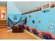A themed bedroom features custom mural, adding unique character to the space at 128 Godfrey Rd, Edgewater, FL 32141