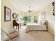A charming bedroom featuring a desk, bay windows, neutral walls, and a ceiling fan at 128 Godfrey Rd, Edgewater, FL 32141