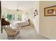 Cozy bedroom featuring carpet, a ceiling fan, and a large window for plenty of natural light at 128 Godfrey Rd, Edgewater, FL 32141