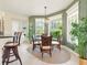 Bright breakfast nook featuring a breakfast bar, and big windows overlooking a green backyard at 128 Godfrey Rd, Edgewater, FL 32141