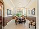 Dining room with large bay window, round table, chandelier and decorative tray ceiling at 128 Godfrey Rd, Edgewater, FL 32141