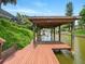 Covered boat dock with a hammock overlooking the serene canal waters at 128 Godfrey Rd, Edgewater, FL 32141