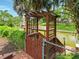 Dock entrance with a gate, offering waterfront access and serene canal views at 128 Godfrey Rd, Edgewater, FL 32141