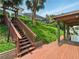 Steps leading to a dock with a covered boat lift overlooking a tranquil canal at 128 Godfrey Rd, Edgewater, FL 32141