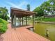 Covered wooden dock featuring a hammock overlooking the serene canal waters at 128 Godfrey Rd, Edgewater, FL 32141