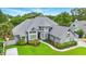 Charming two-story home with gray roof, manicured lawn and a welcoming red front door at 128 Godfrey Rd, Edgewater, FL 32141