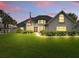 Picture-perfect home with a lush green lawn, featuring landscape lighting and a brick accent wall at 128 Godfrey Rd, Edgewater, FL 32141