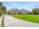 Beautiful two-story home with a well-manicured lawn and a long driveway at 128 Godfrey Rd, Edgewater, FL 32141