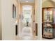 Hallway featuring tile floor, display cabinet, chair rail and decorative wall niche at 128 Godfrey Rd, Edgewater, FL 32141