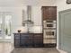 The kitchen showcases modern appliances, dark cabinets, and a stylish vent hood at 128 Godfrey Rd, Edgewater, FL 32141
