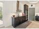 Beautiful kitchen featuring dark cabinetry, stainless appliances and a stylish range hood at 128 Godfrey Rd, Edgewater, FL 32141