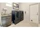 Modern laundry room with front-load washer and dryer, granite countertop, and ample storage at 128 Godfrey Rd, Edgewater, FL 32141
